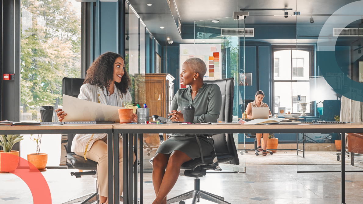 Two women discussing how to hire a marketing agency