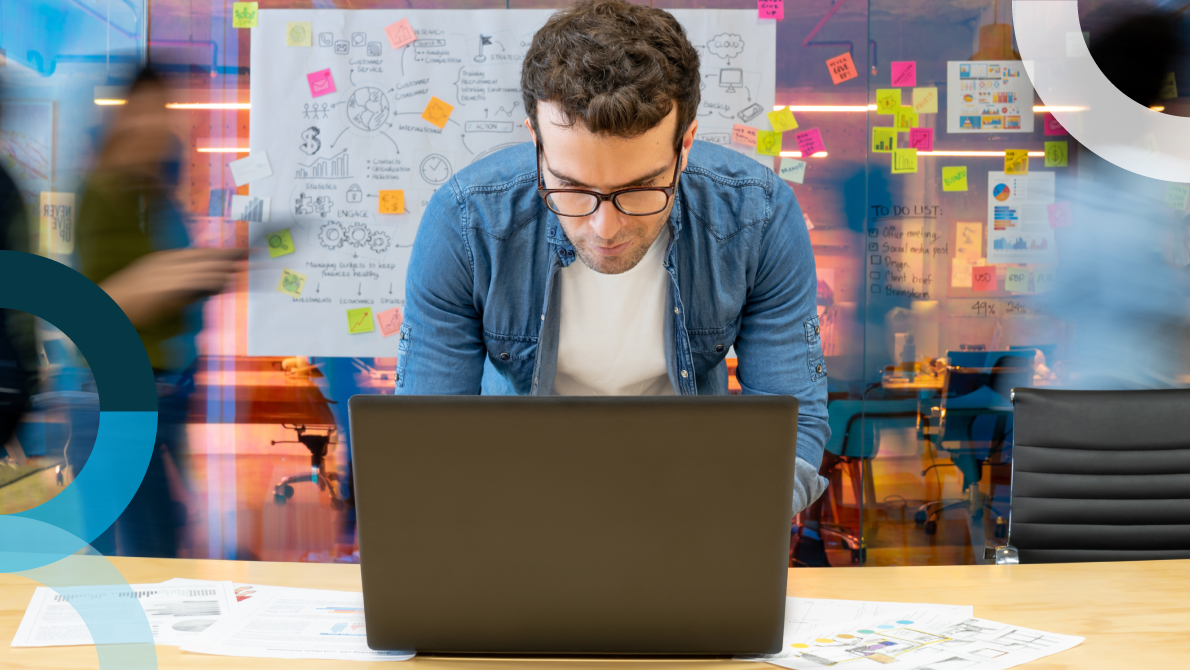 Employee looking at a computer and experiencing marketer burnout