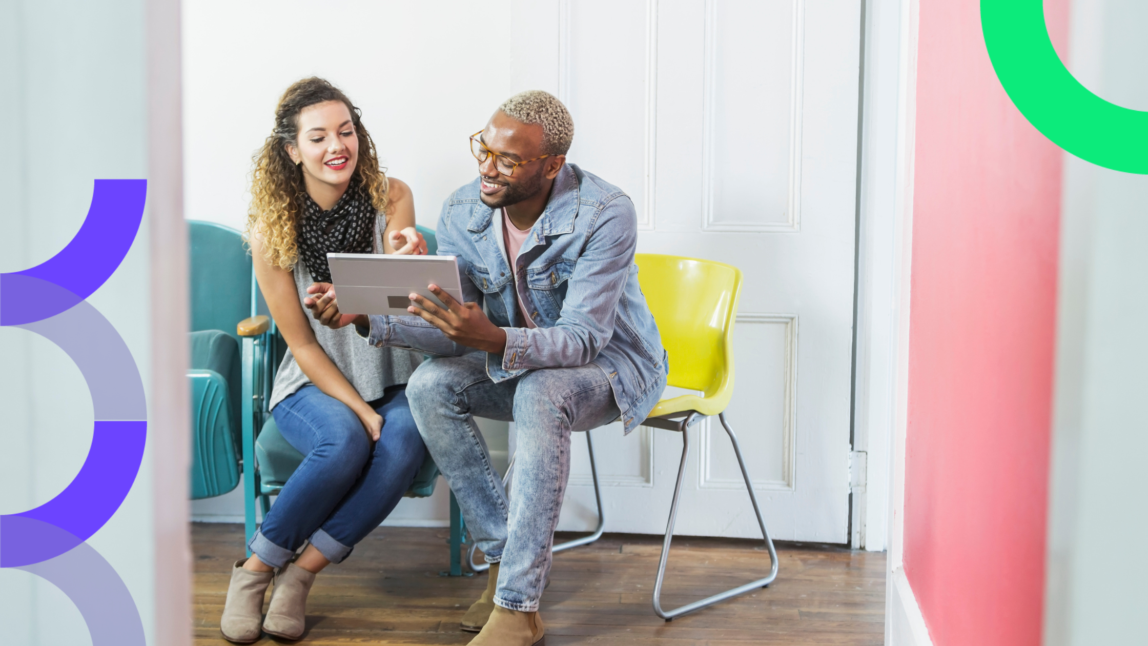 Two marketers looking at the best eBooks on a tablet