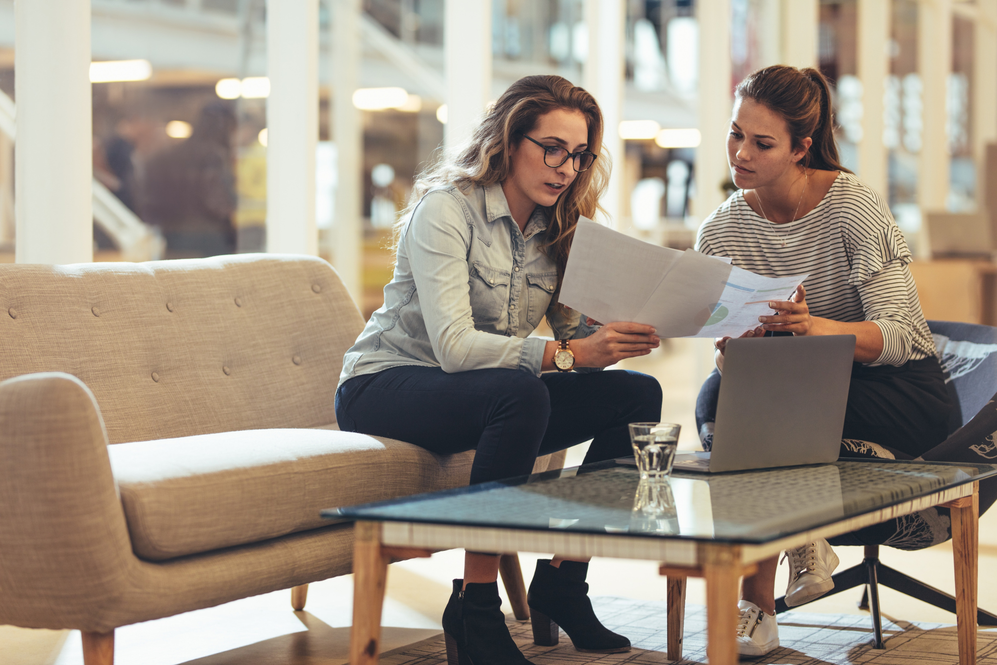 Two women looking at one-pagers